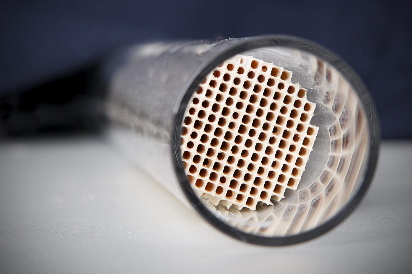 A cylindrical catalytic converter block with a fine honeycomb surface — a real heterogeneous catalyst