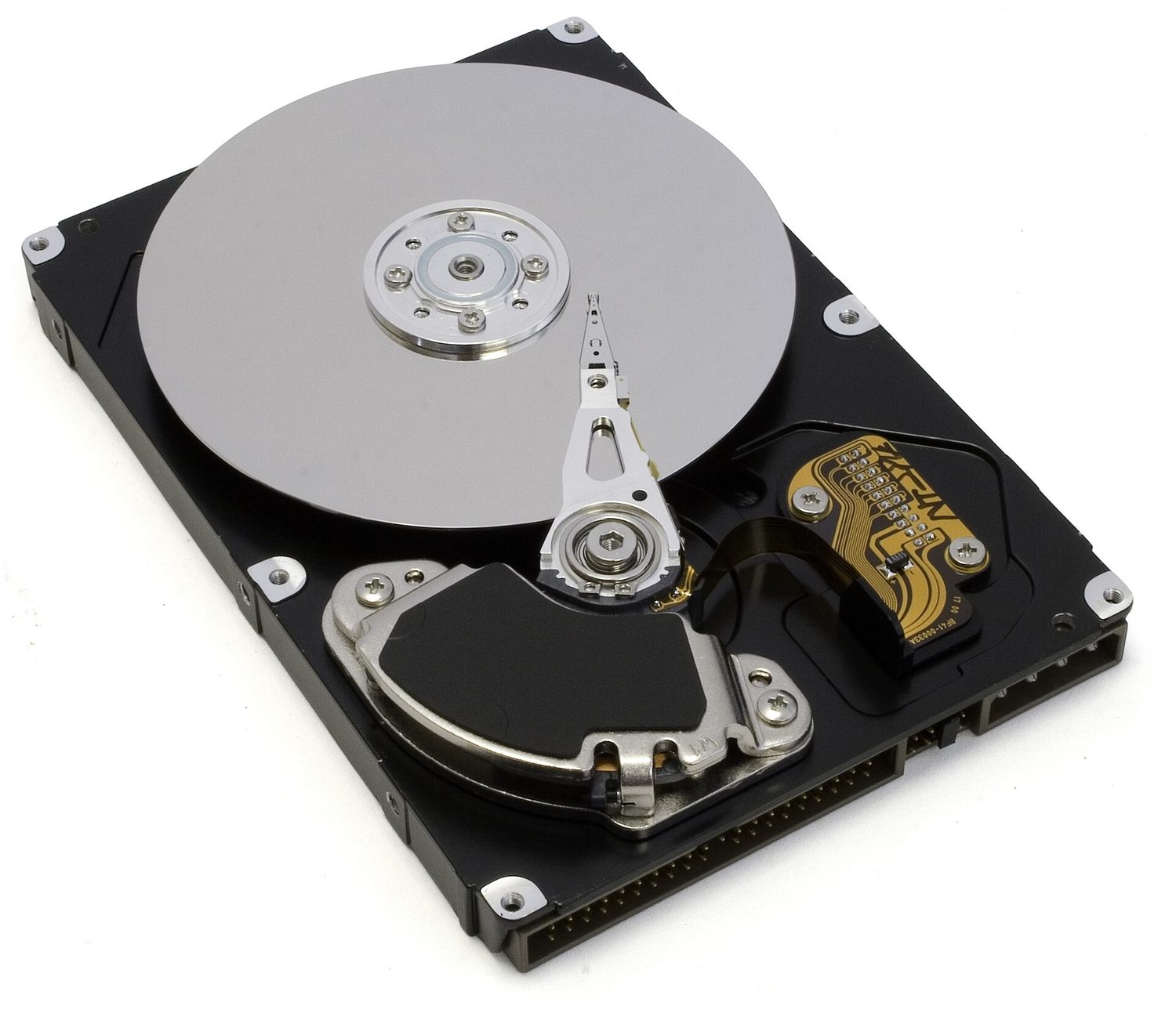 An opened 3.5-inch hard disk drive: a shiny circular platter with the actuator arm and read/write head resting over it