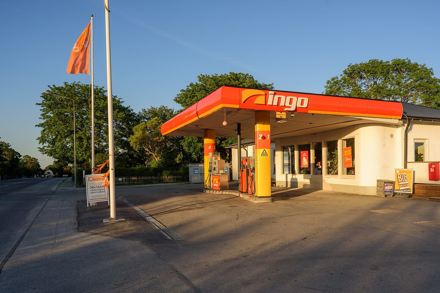 A petrol station forecourt: petrol has price-inelastic demand, so a price rise cuts the quantity bought only a little