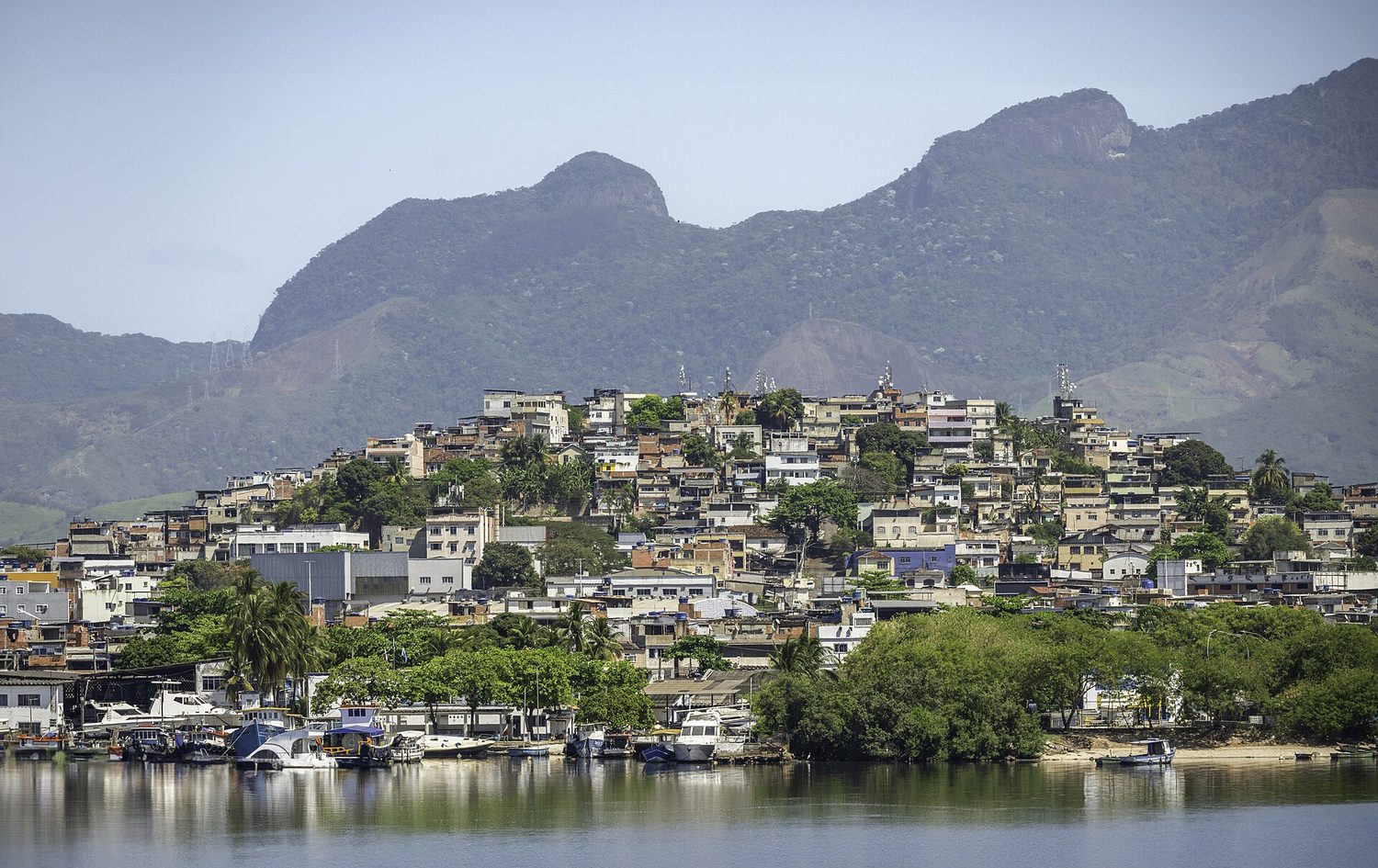 A hillside informal settlement overlooking a wealthier city district