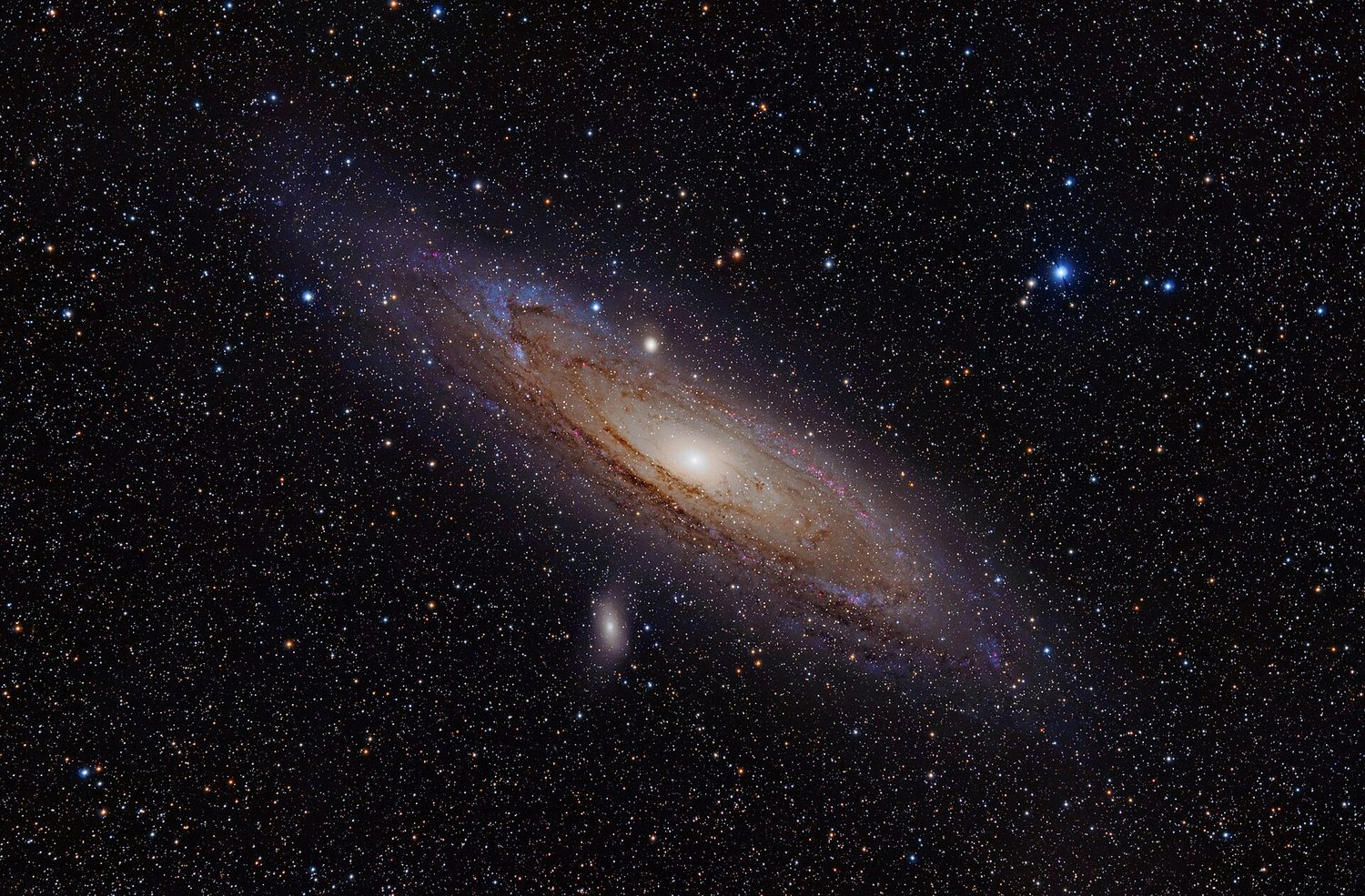 A spiral galaxy seen at an angle, with a bright glowing core, dust lanes winding through its disc, and two small companion galaxies nearby, set against a star field