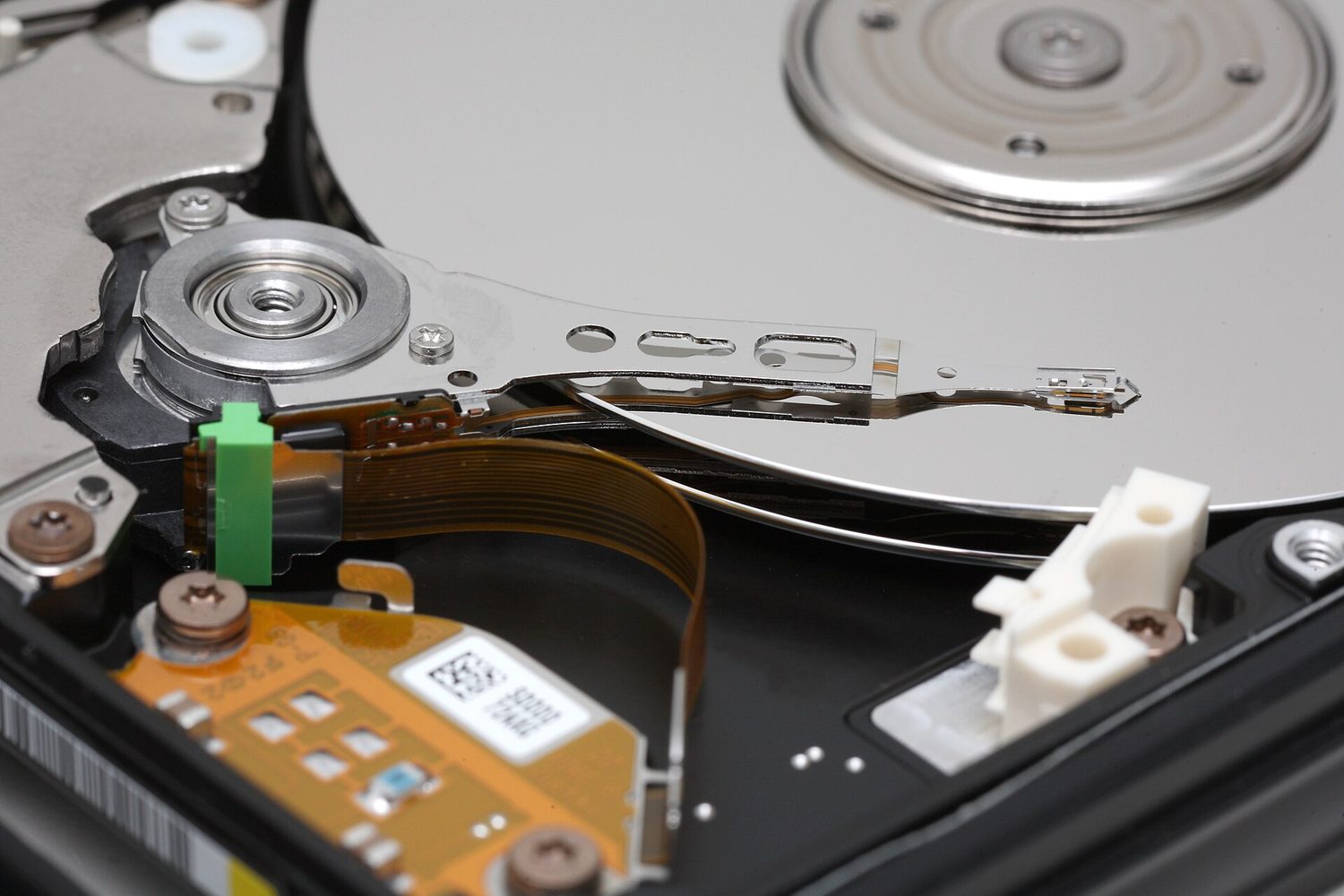 Hard-disk platters and head: data compressed and stored as magnetic patterns
