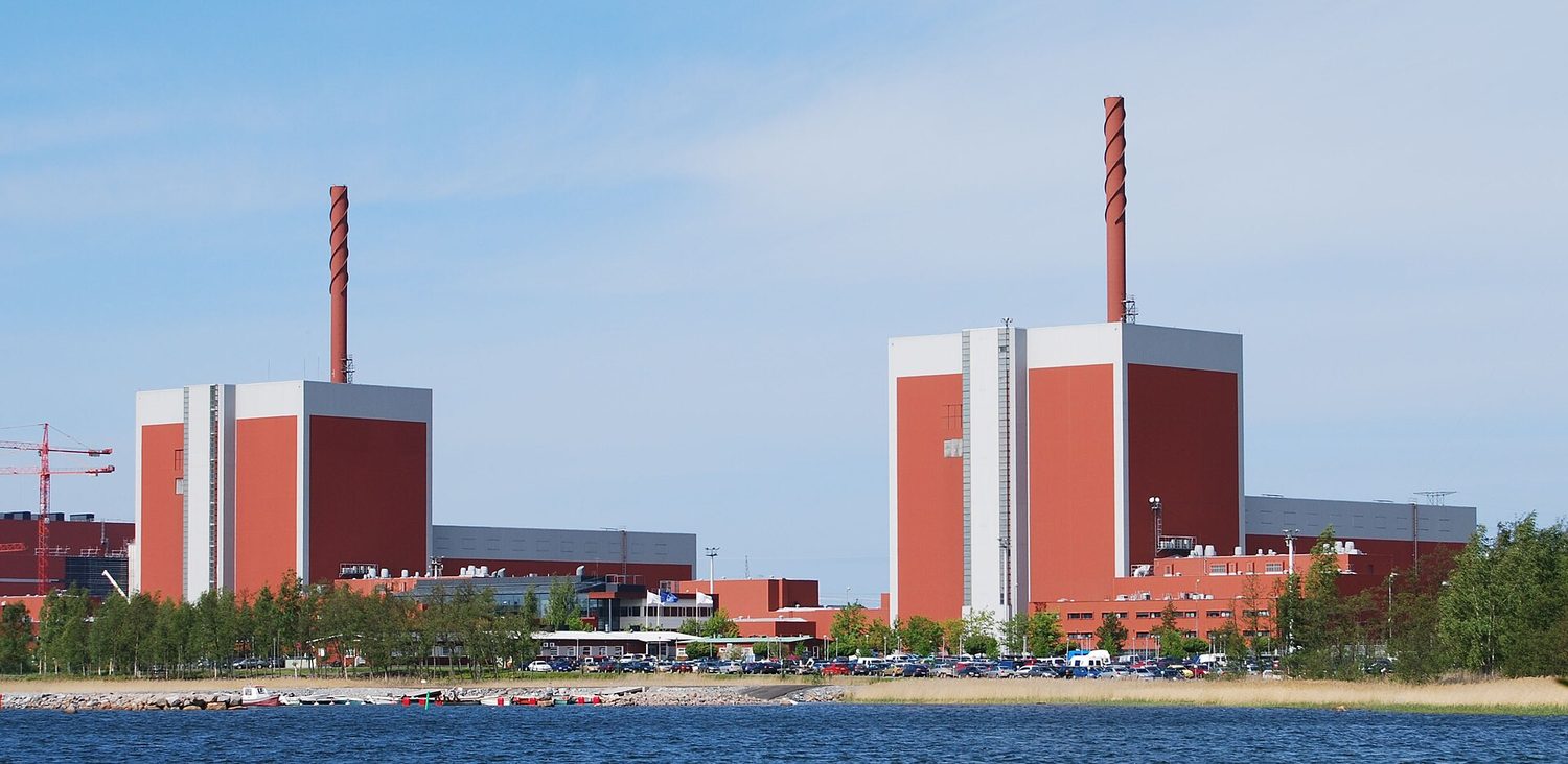 A nuclear power station beside the sea: two large rectangular reactor buildings, using seawater for cooling
