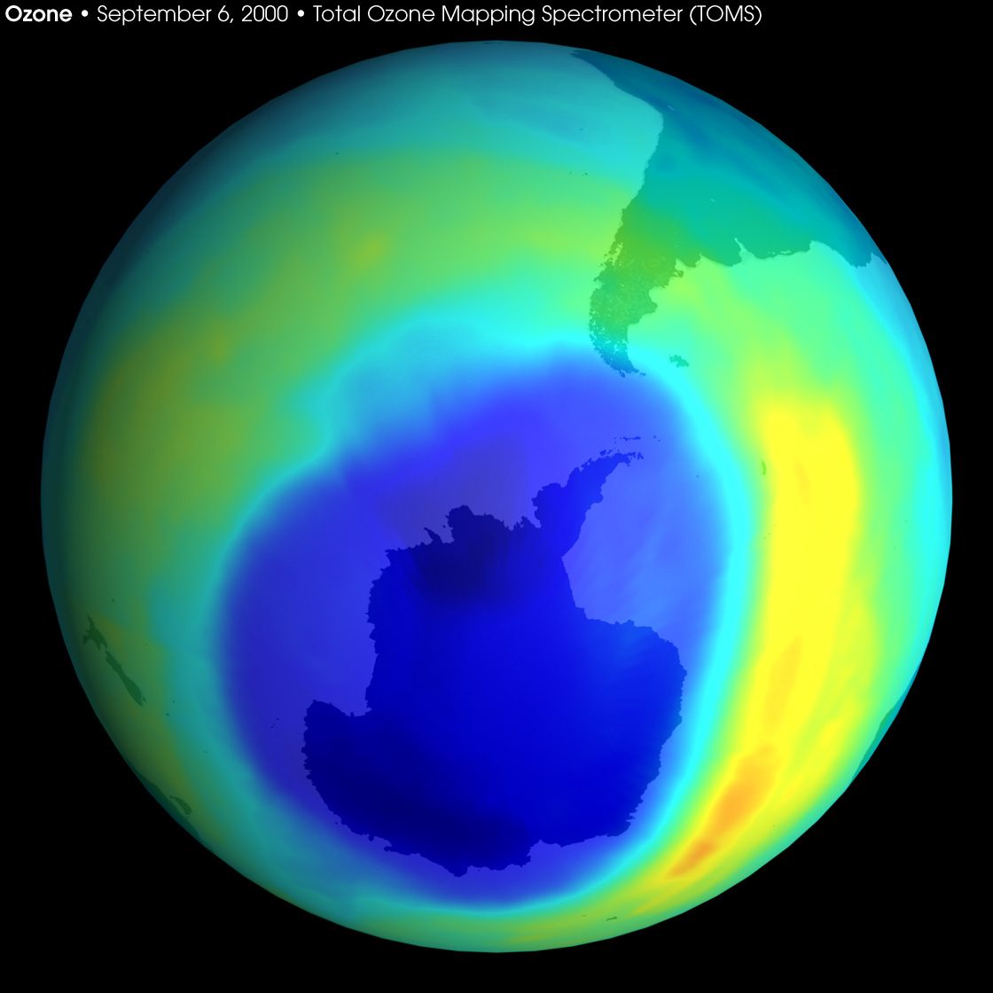 A NASA satellite map of the Southern Hemisphere with a large dark-blue patch of very low ozone centred over Antarctica