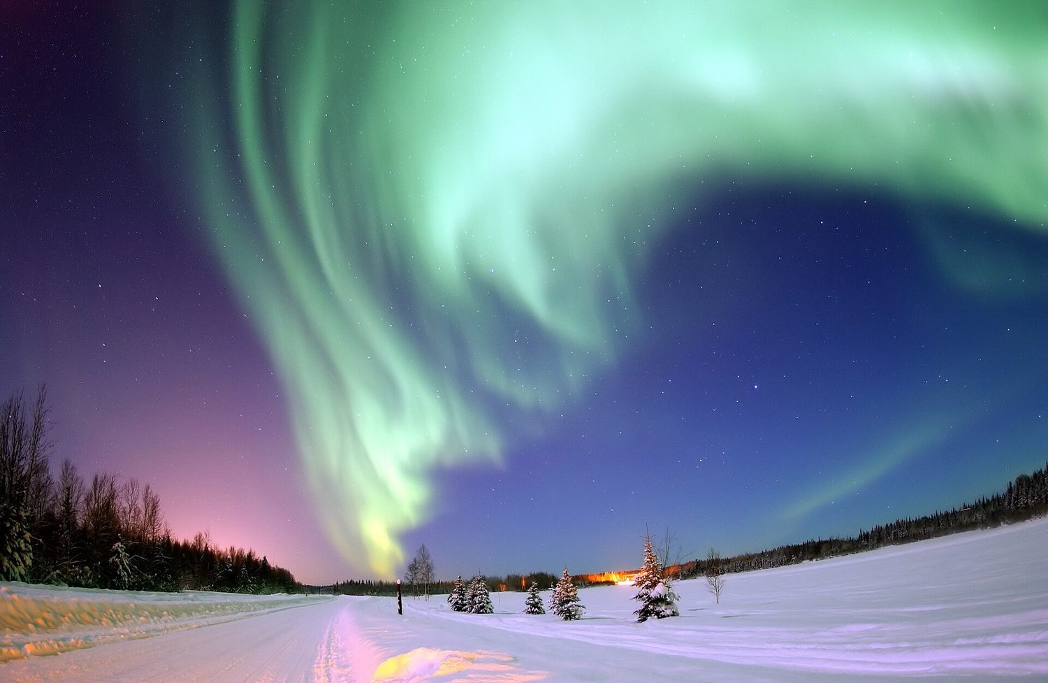 An aurora: charged particles from the Sun are steered by Earth's magnetic field toward the poles