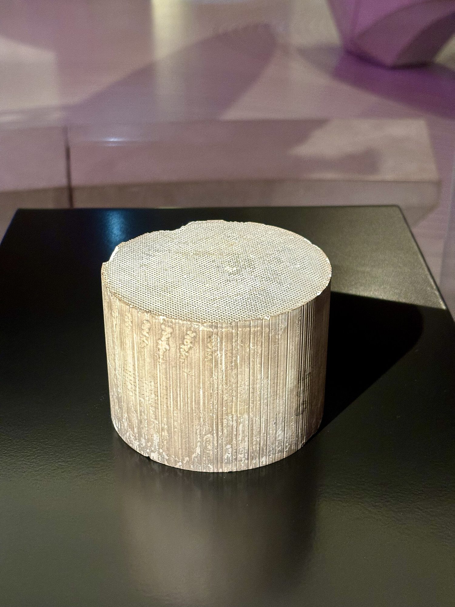 The ceramic honeycomb core taken out of a catalytic converter, showing thousands of tiny channels