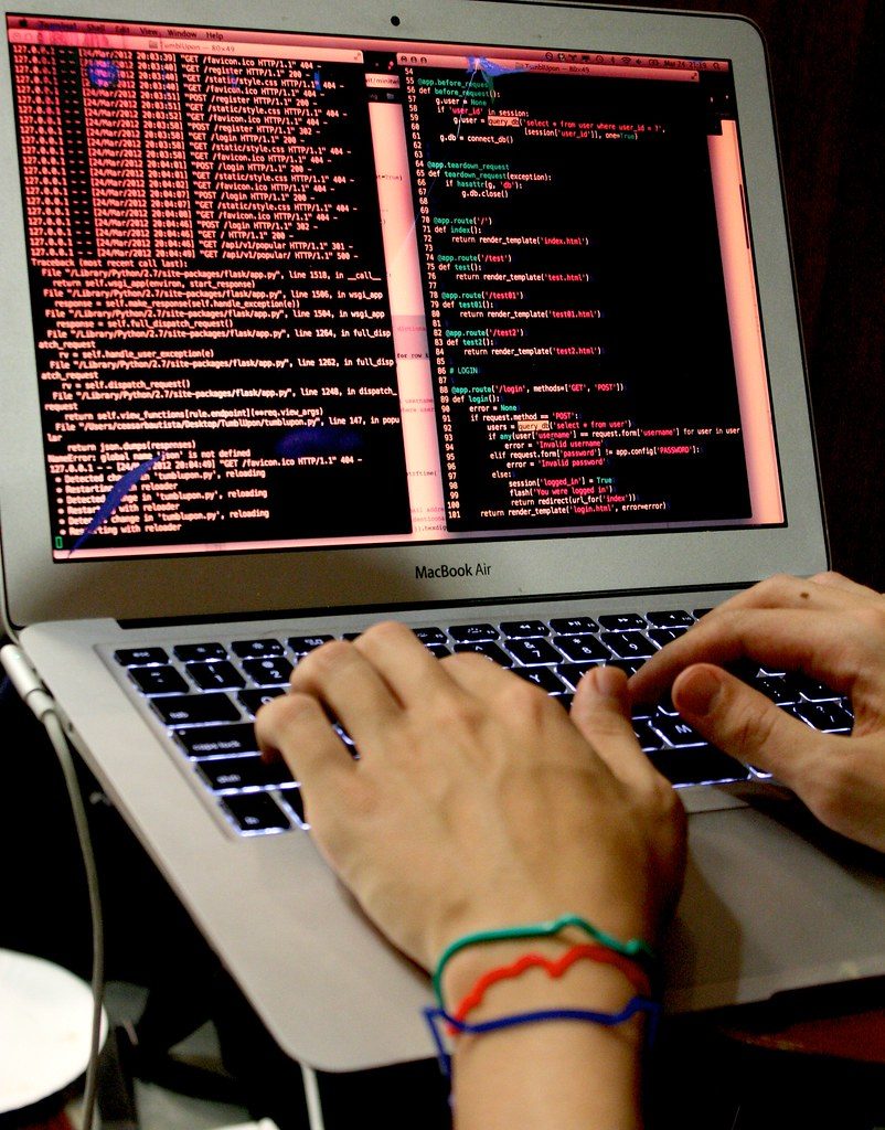 A programmer typing code at a computer