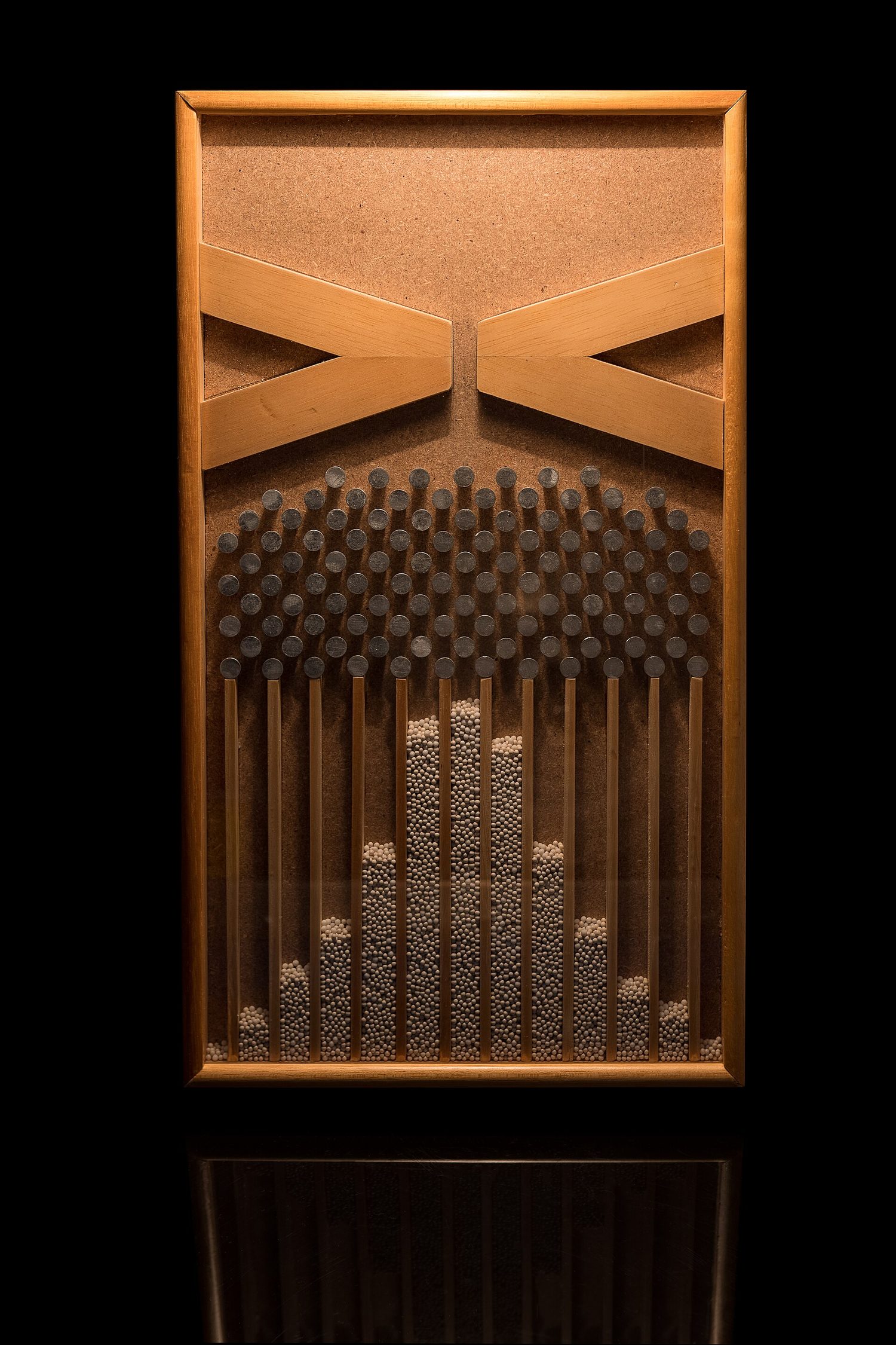 A Galton board forming a bell shape