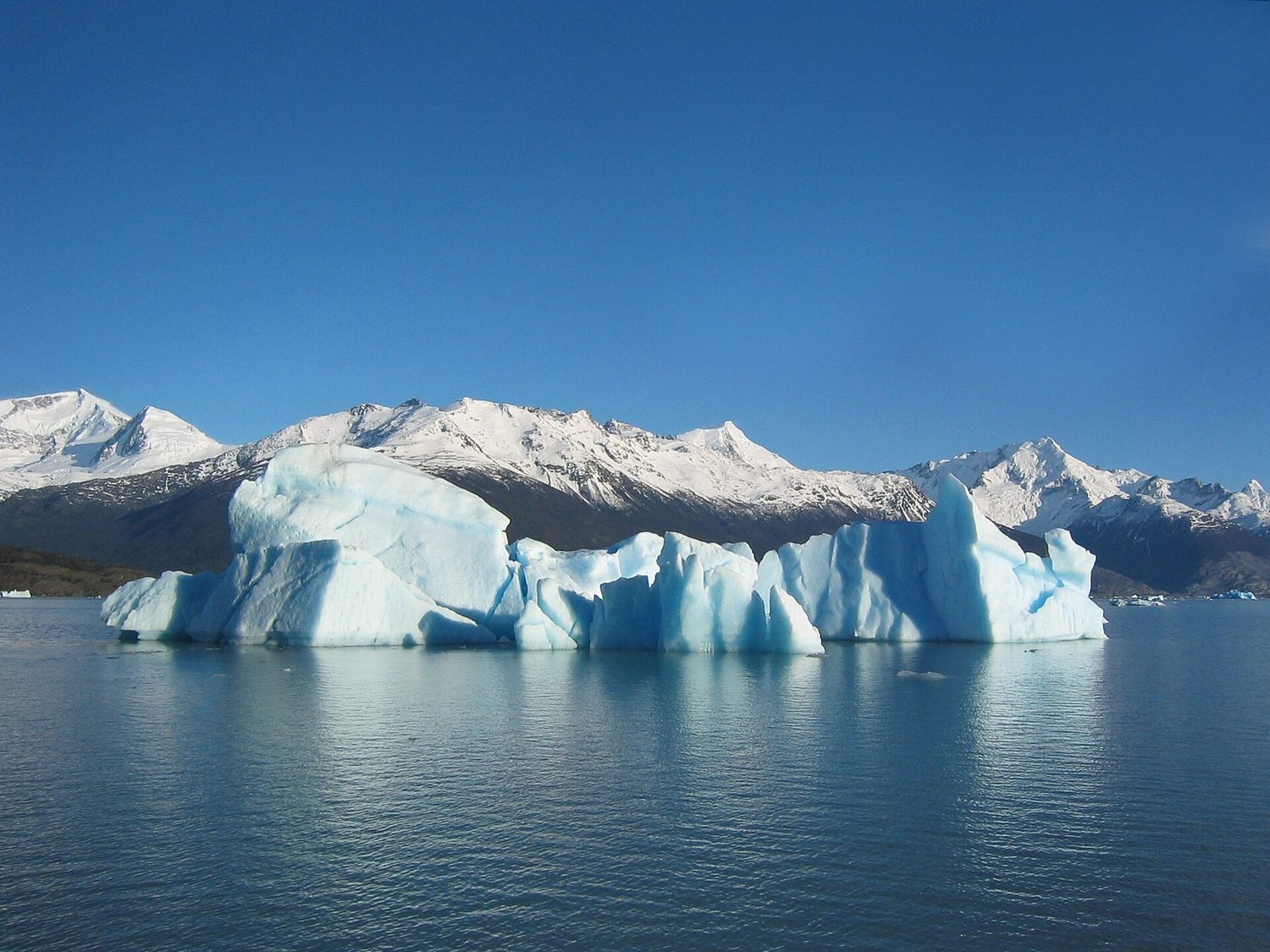 An iceberg floats with most of its volume hidden: ice is slightly less dense than water