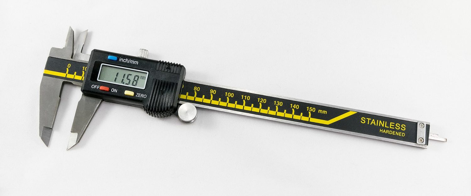 A digital vernier caliper with a readout showing 11.58 mm